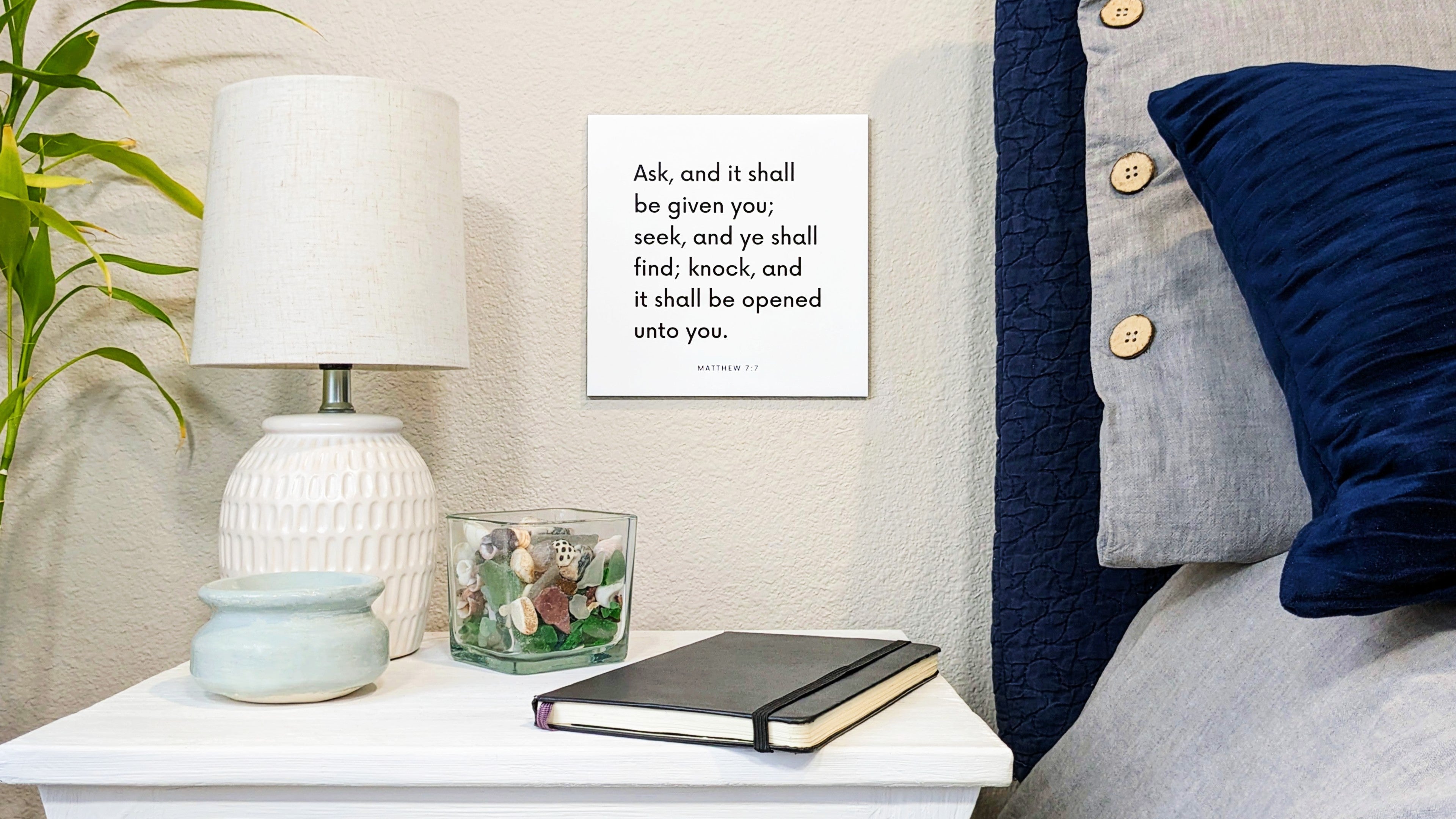 Bedside and nightstand with a scripture tile on the wall