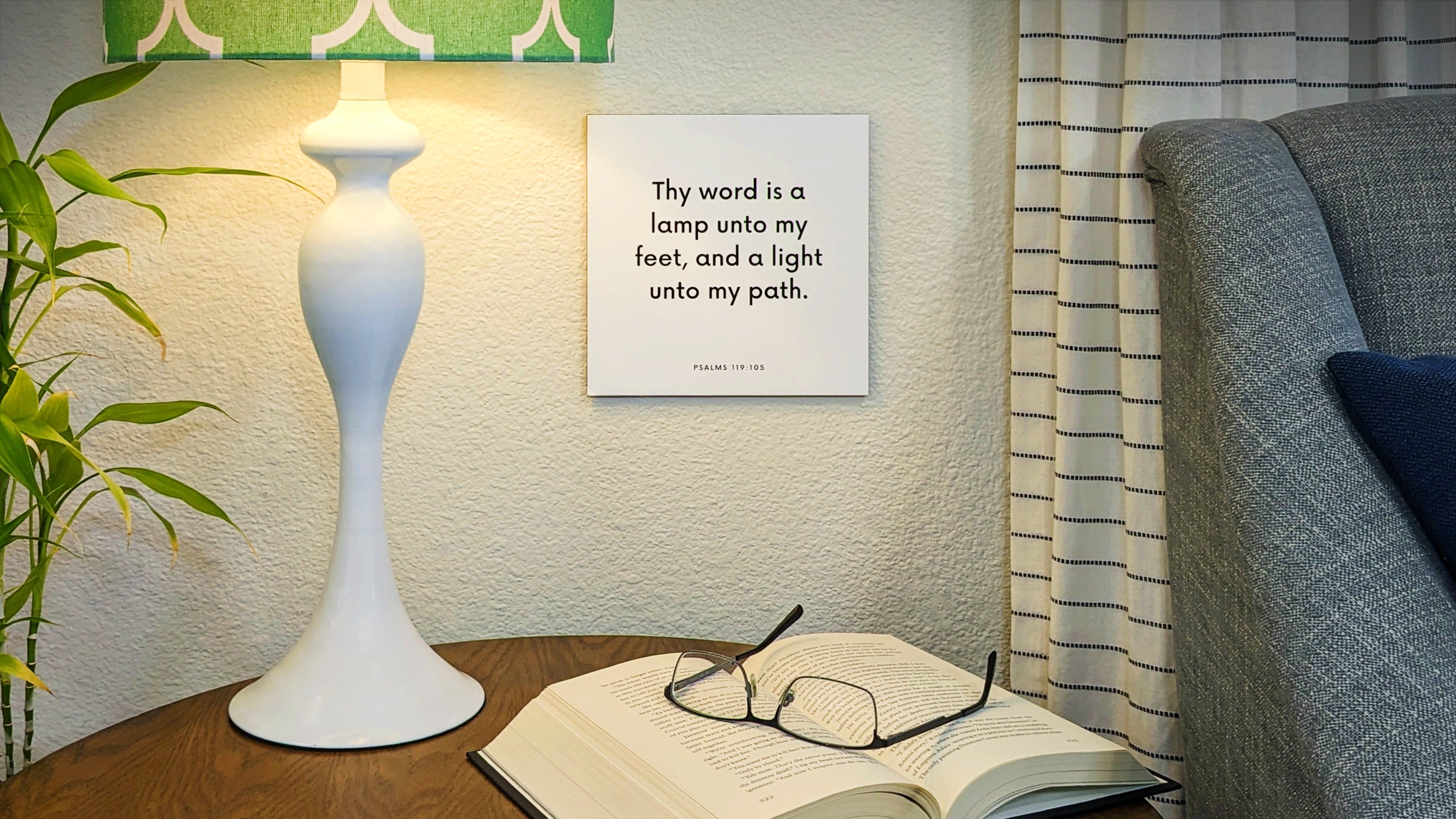Lamp and end table with a scripture tile on the wall