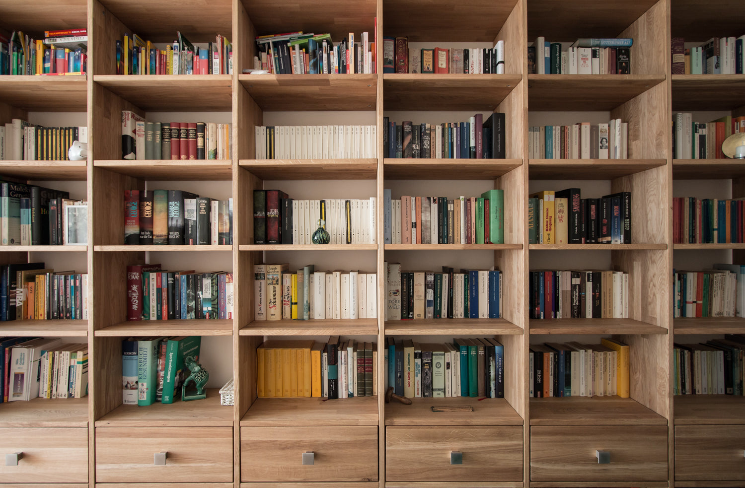 Wall of bookshelves loaded with books